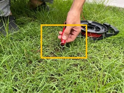 A person using a tool to cut grass

AI-generated content may be incorrect.