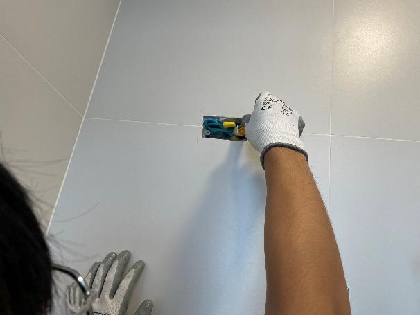 A person using a tool to install a tile

AI-generated content may be incorrect.